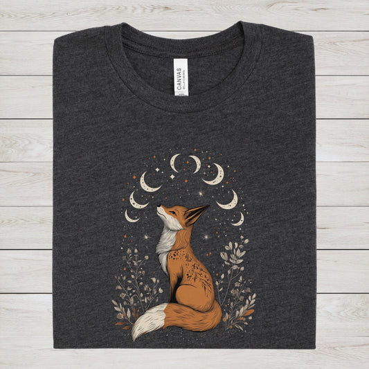 Dark heather gray t-shirt with a fox and moon design on a wooden surface