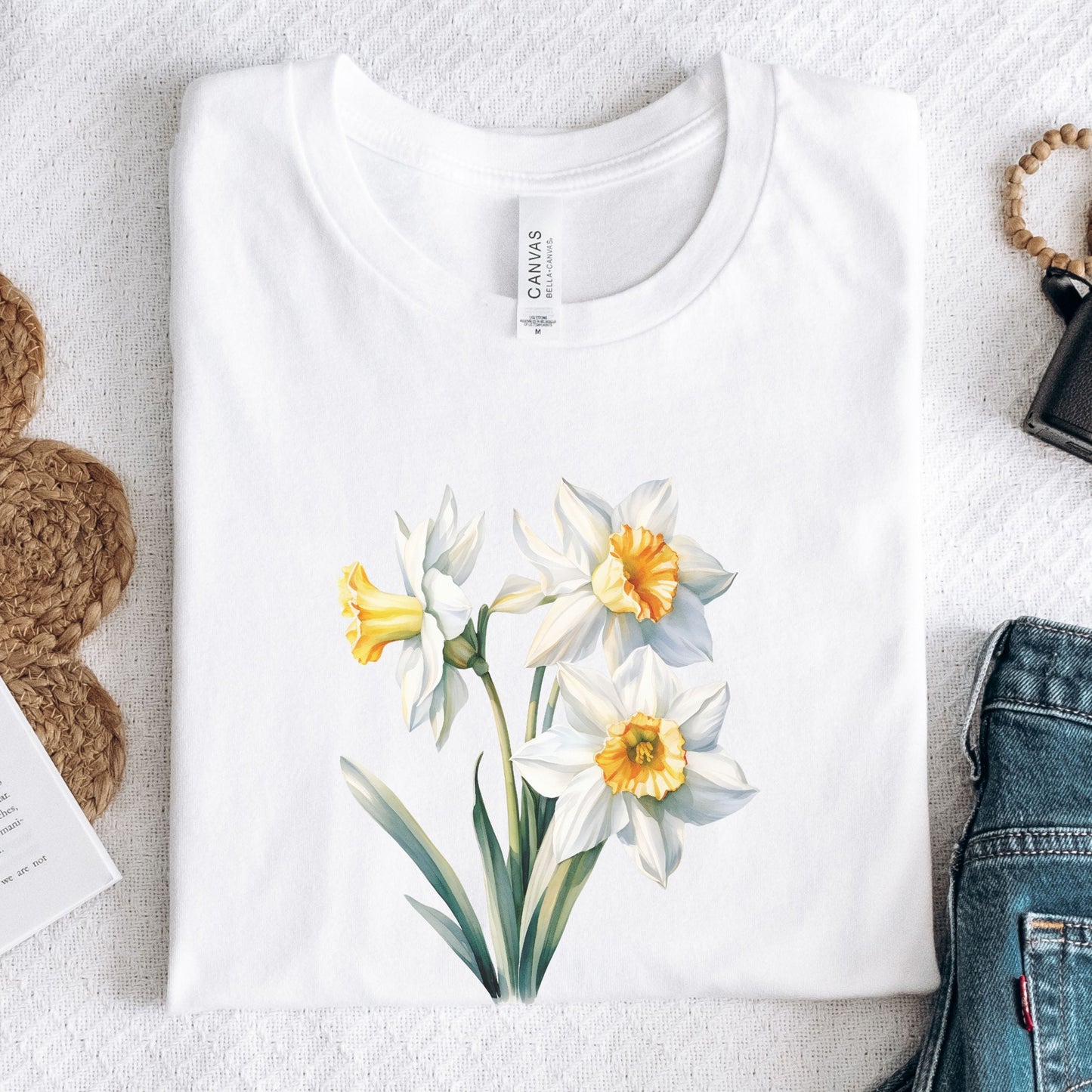 White t-shirt with floral design on a light gray surface