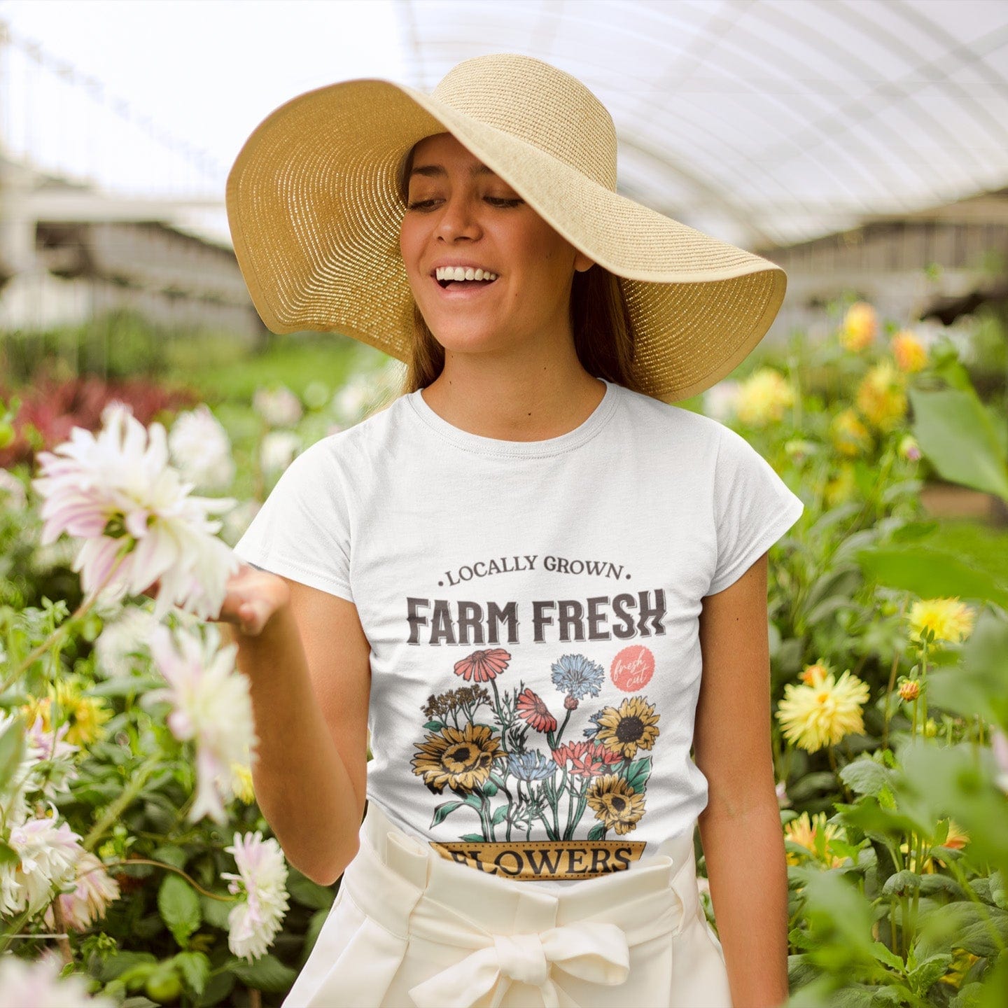 Woman wearing a 'Farm Fresh' t-shirt in a garden setting