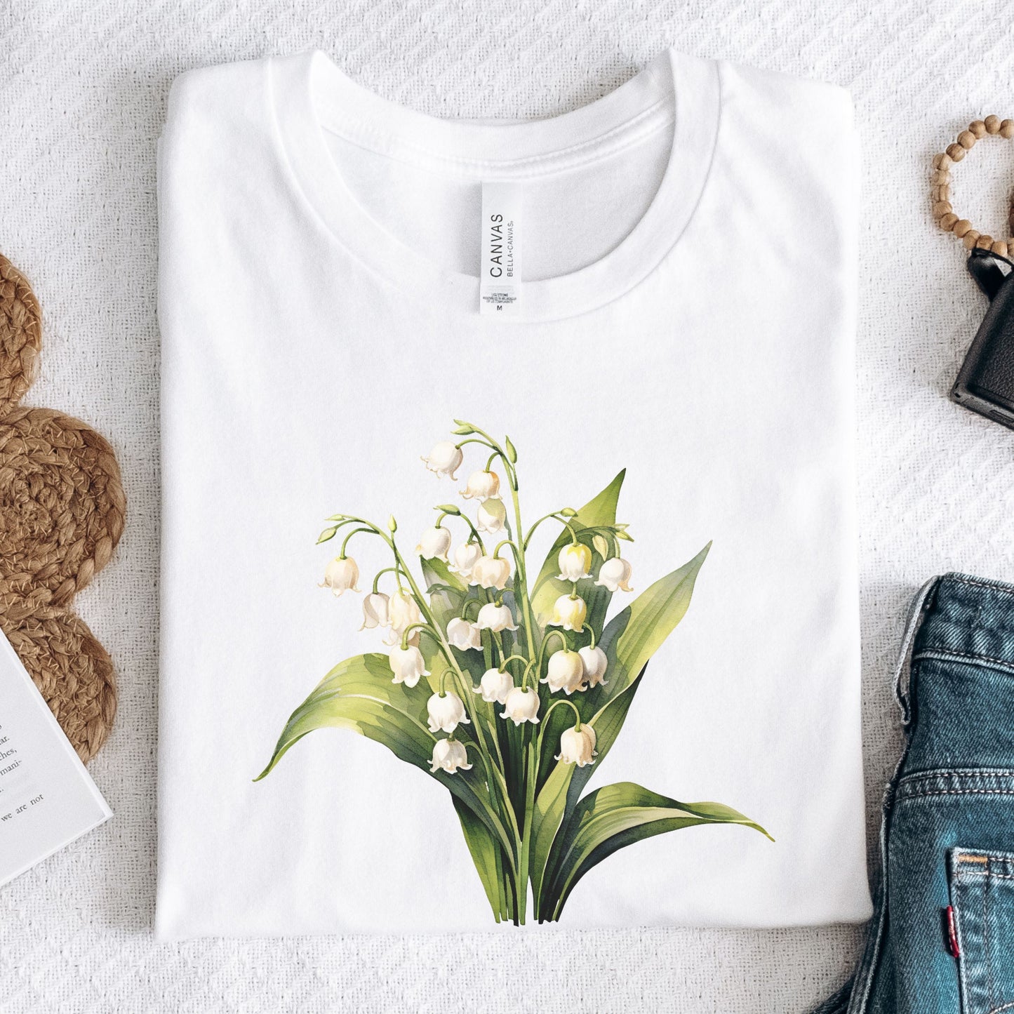 White t-shirt with a floral design on a light gray surface