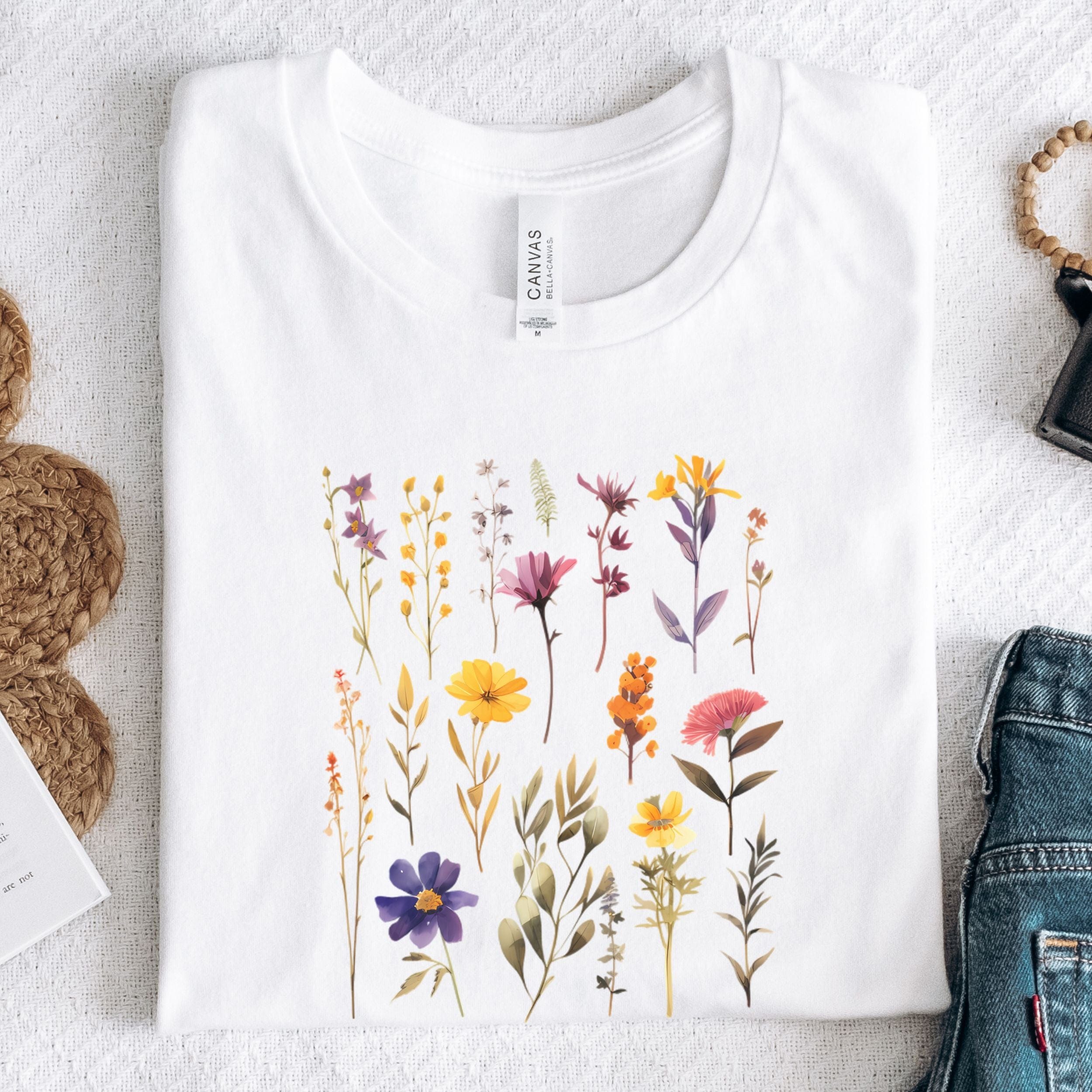 White t-shirt with floral design on a textured surface