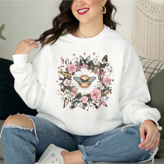 Person wearing a white sweatshirt with floral and butterfly design