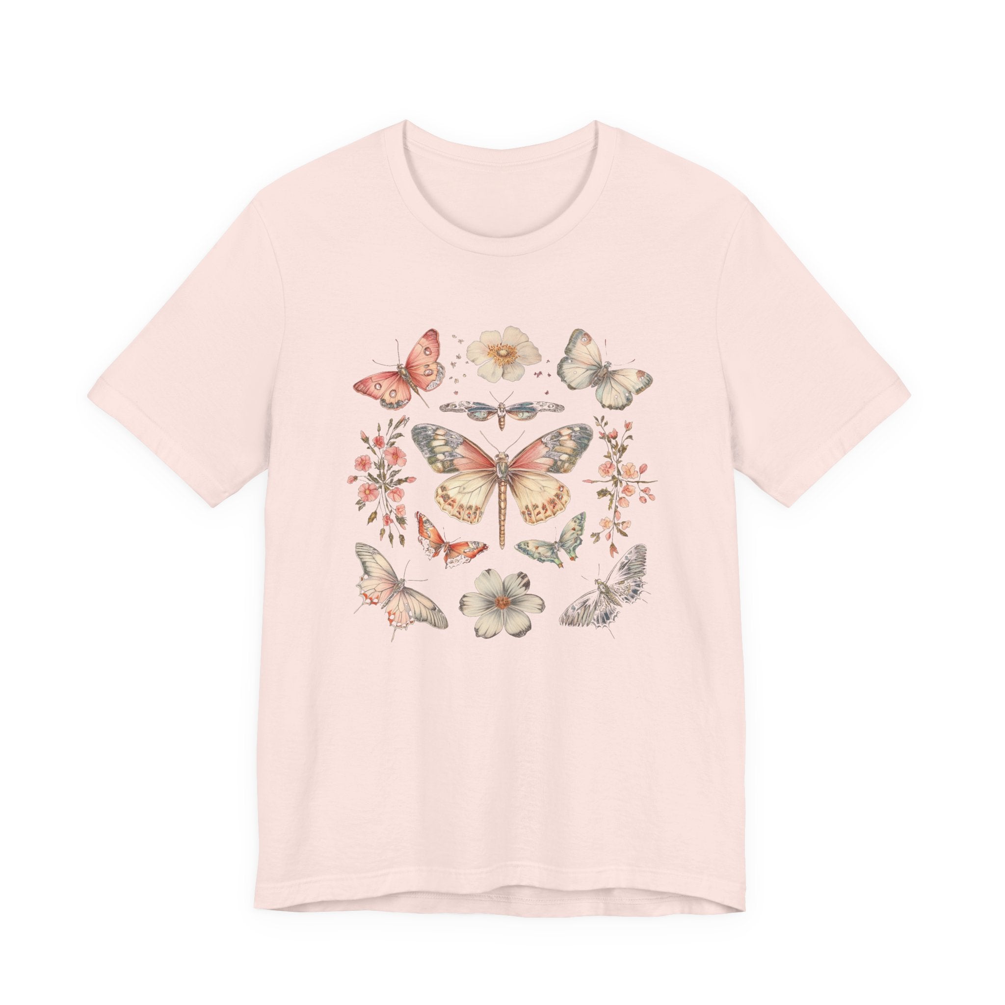 Flat lay of soft pink t-shirt featuring vintage butterfly and floral design
