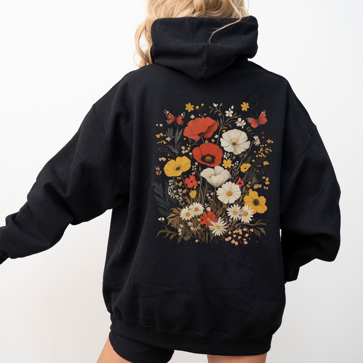 Black hoodie with floral design on the back against a white background