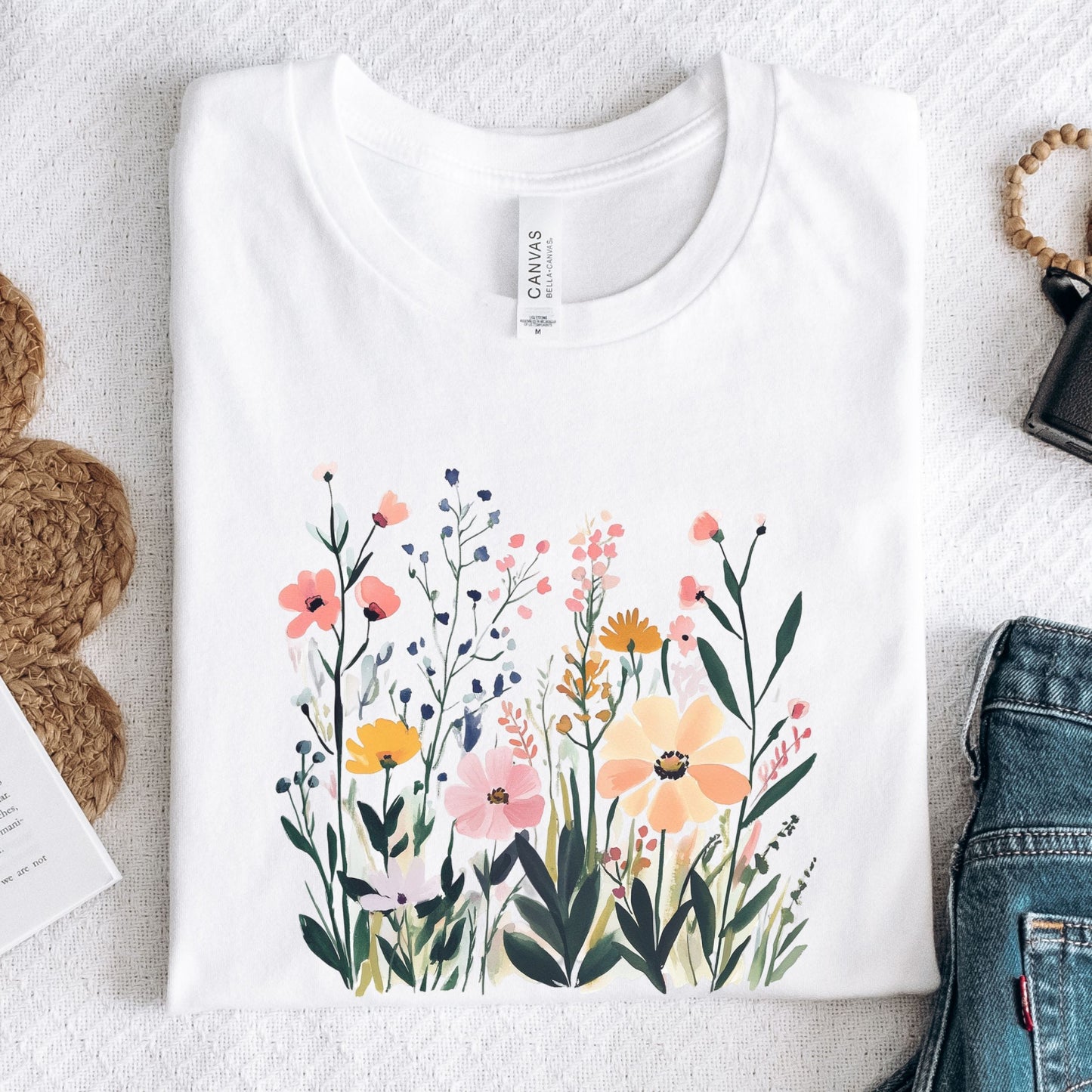 White t-shirt with floral design on a textured surface