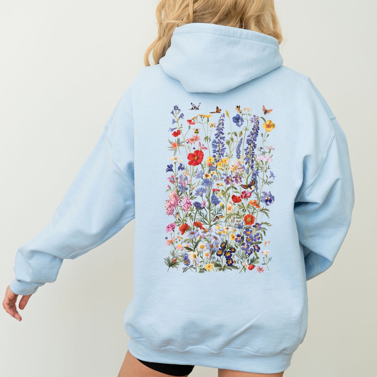 Light blue hoodie with a floral design on the back against a plain background