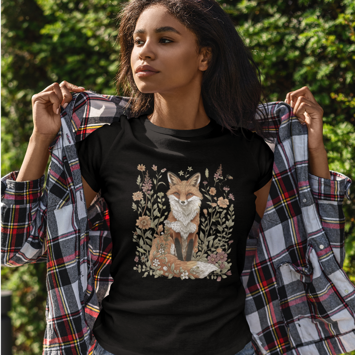 Nature-inspired fox botanical graphic tee featuring woodland florals and vintage garden artwork, styled outdoors with a cozy plaid layer.
