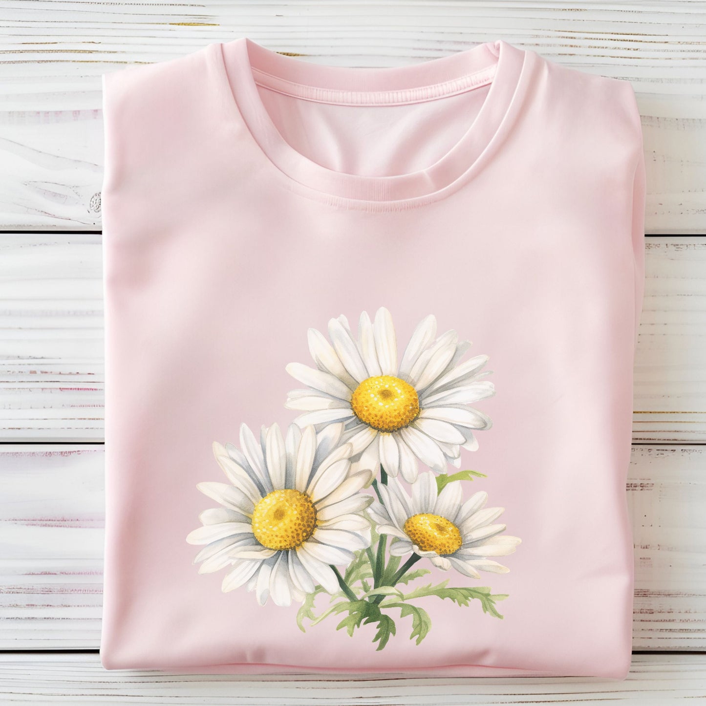 Pink t-shirt with daisy flower design on a wooden surface