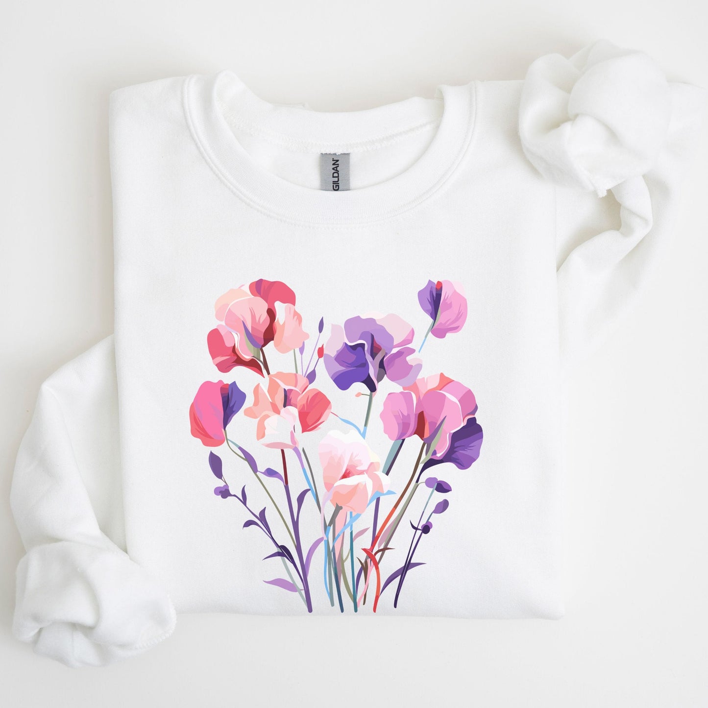 White sweatshirt with a colorful floral design on a light background