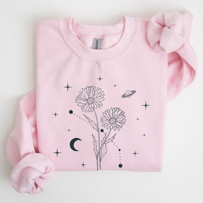 Pink sweatshirt with floral and celestial design on a light gray background