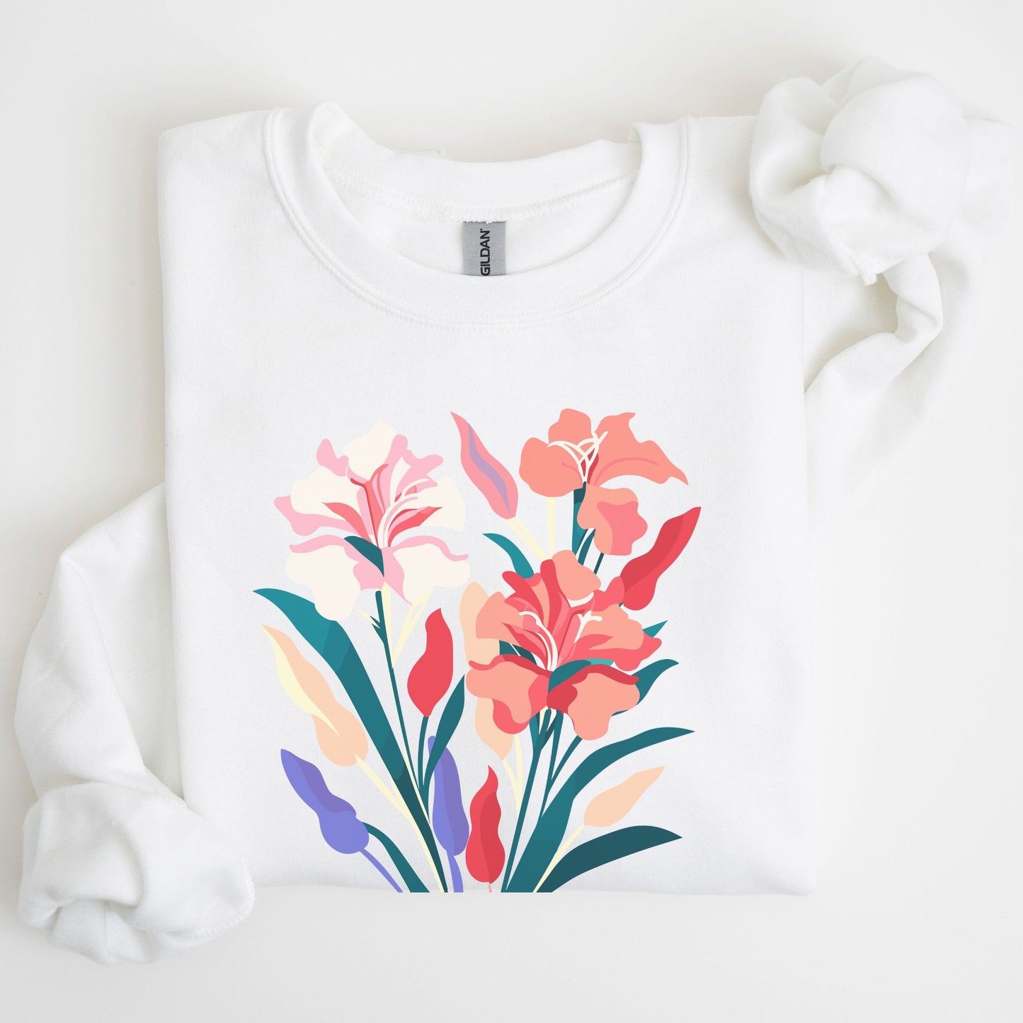 White sweatshirt with colorful floral design on a light background