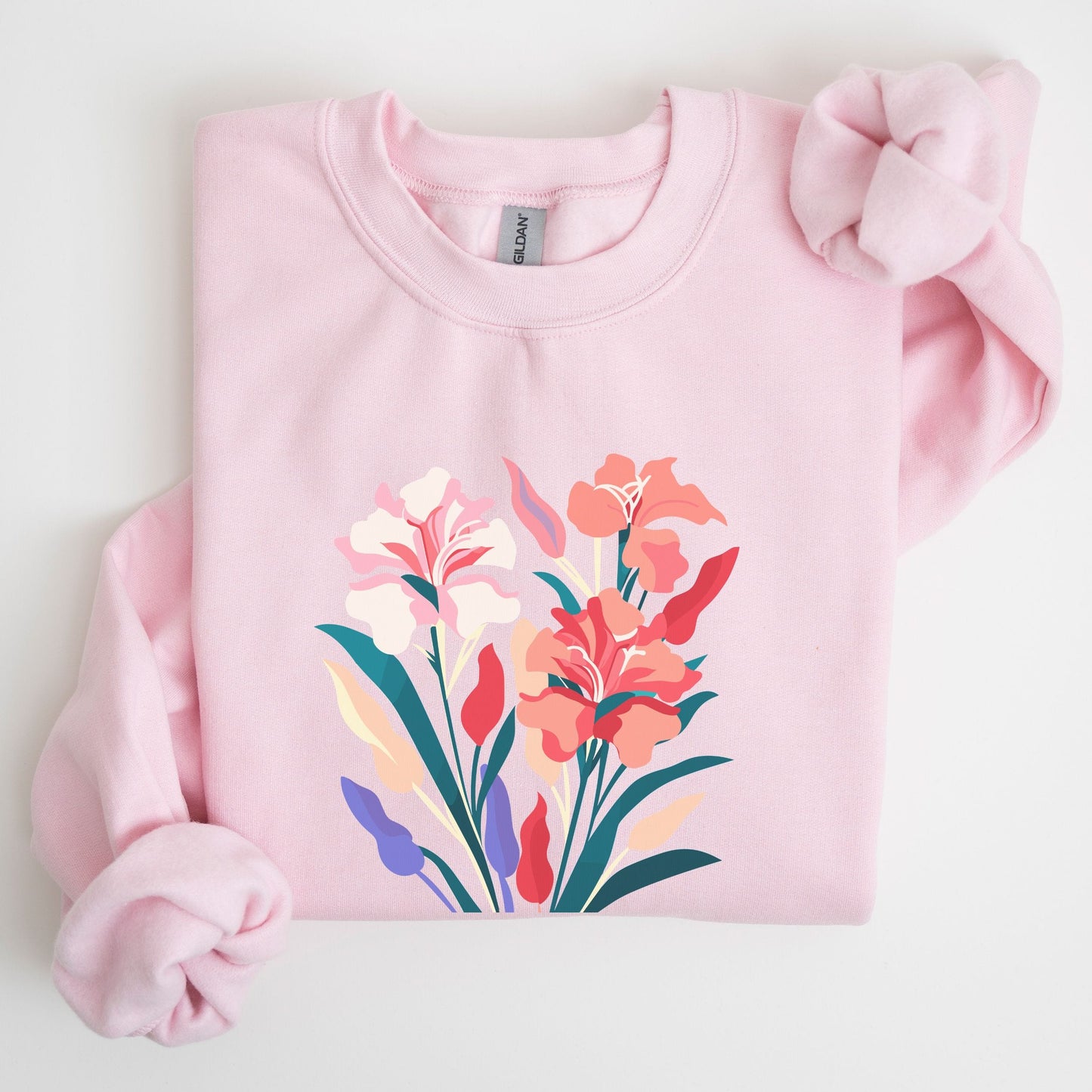 Pink sweatshirt with floral design on a light gray background