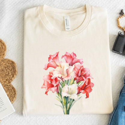 Beige t-shirt with pink and white floral design on a textured surface.