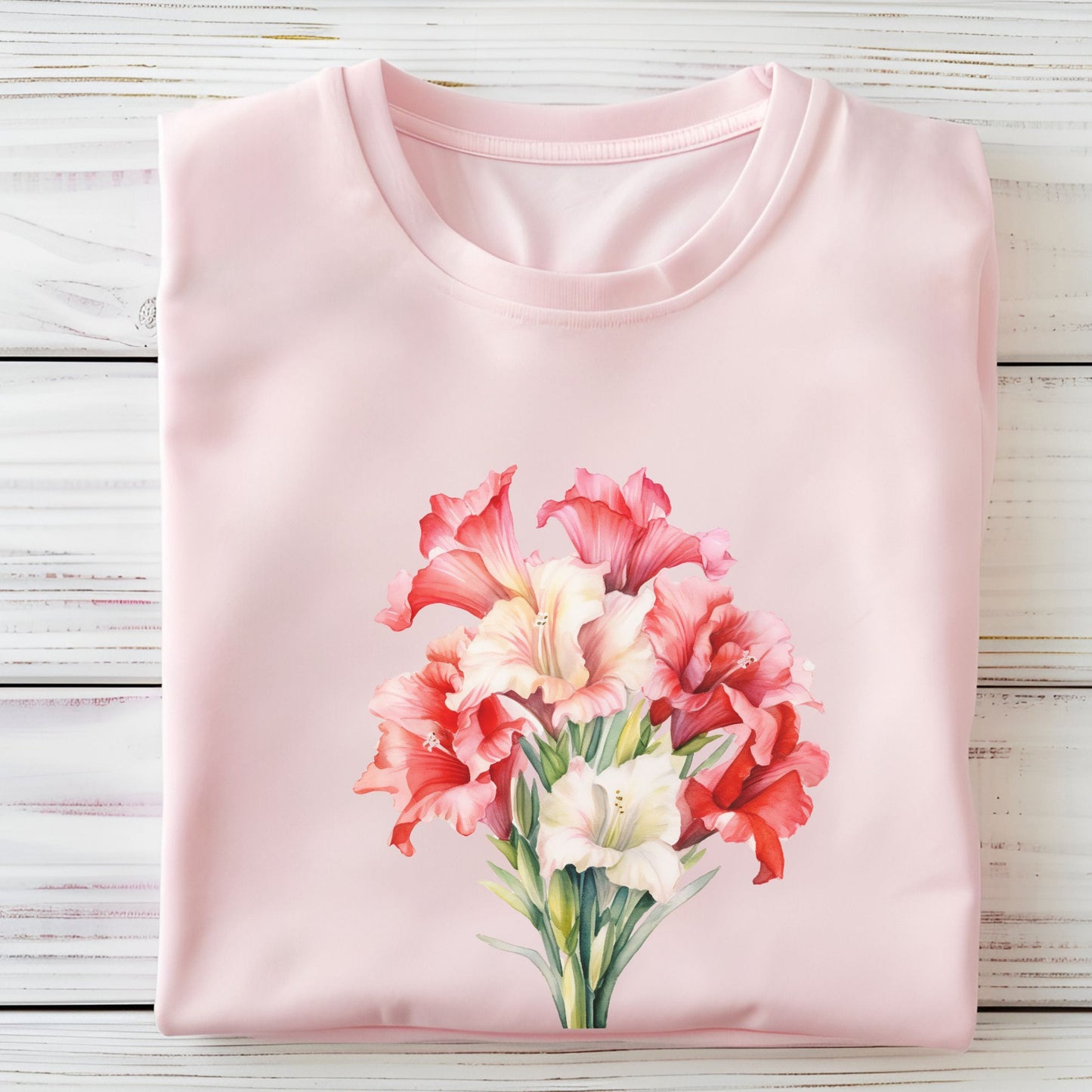 Pink t-shirt with a floral design on a wooden surface