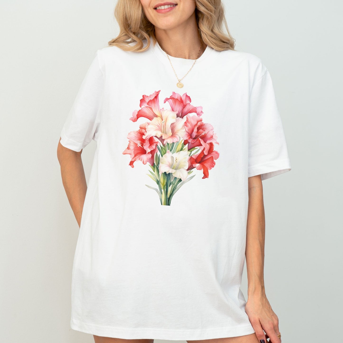 Woman wearing a white t-shirt with a floral design on a plain background