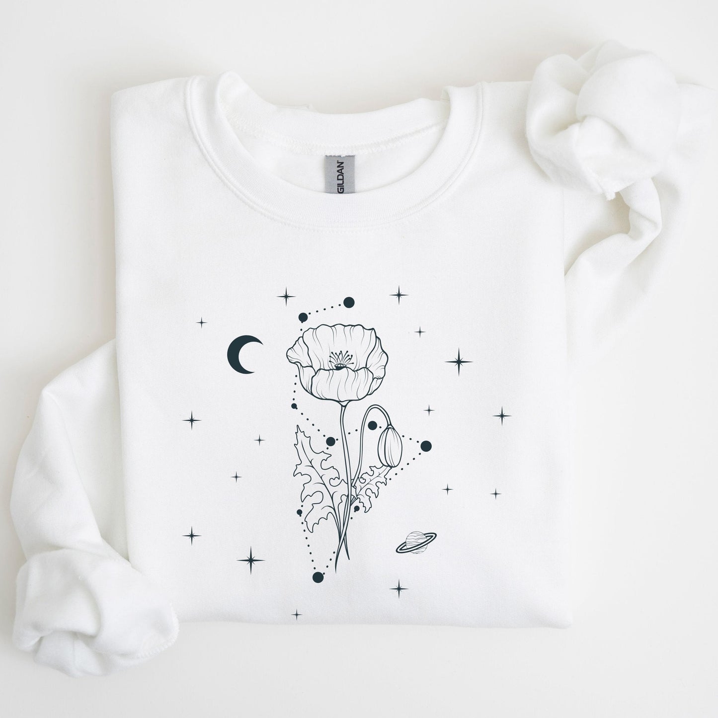 White sweatshirt with black floral and celestial design on a light background