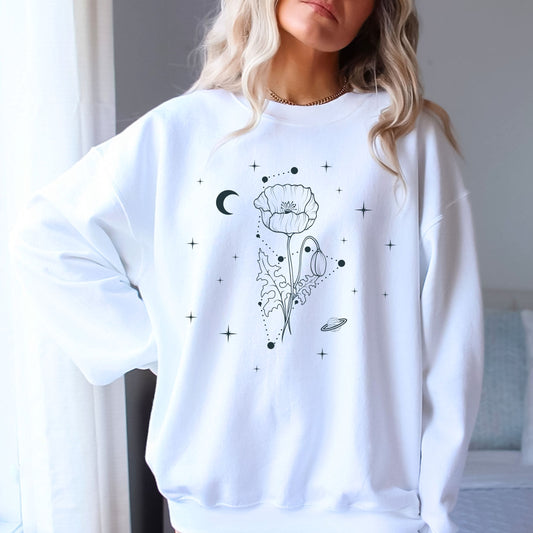 White sweatshirt with black floral and celestial design worn by a person.