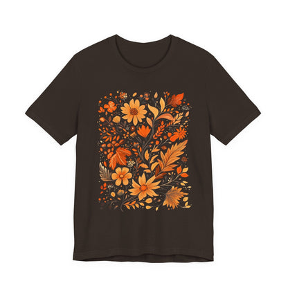 Flat lay of brown t-shirt featuring orange and gold autumn floral design