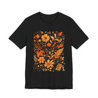 Flat lay of black t-shirt featuring orange and gold autumn floral design
