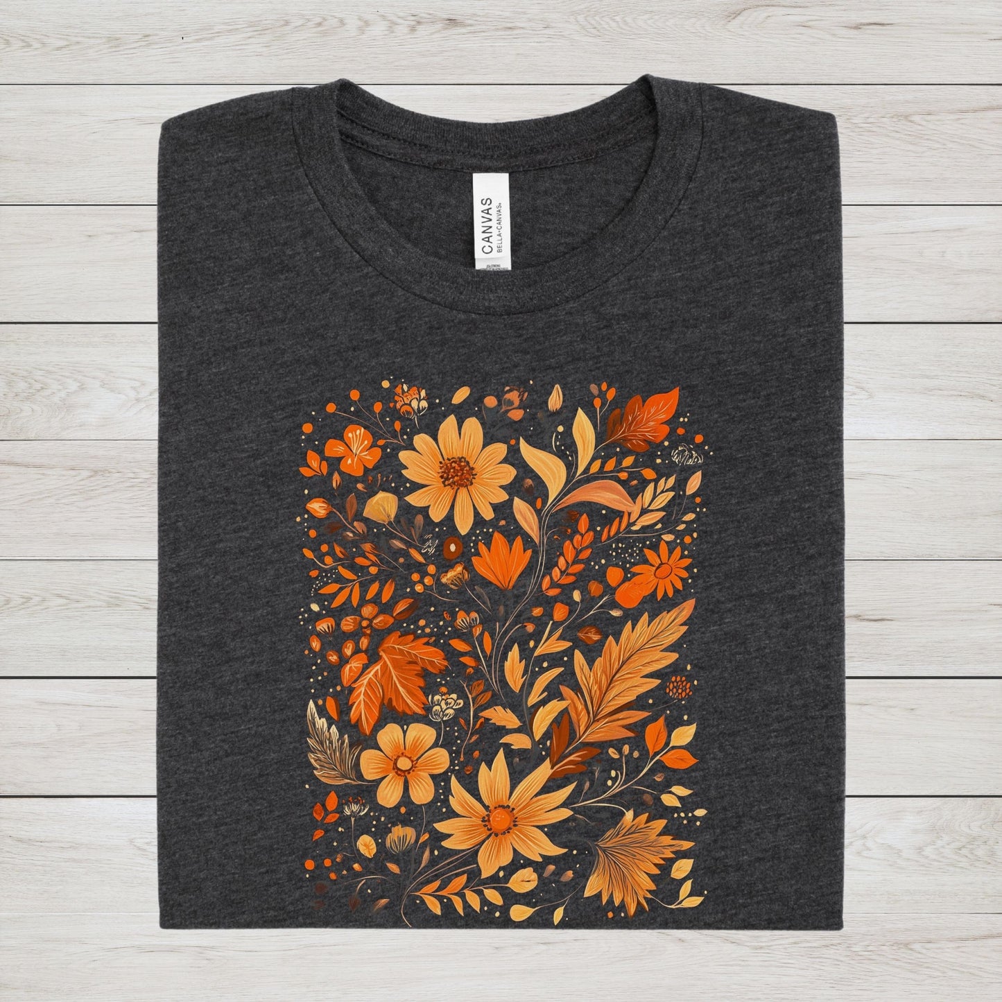 Flat lay of dark grey heather t-shirt featuring orange and gold autumn floral design
