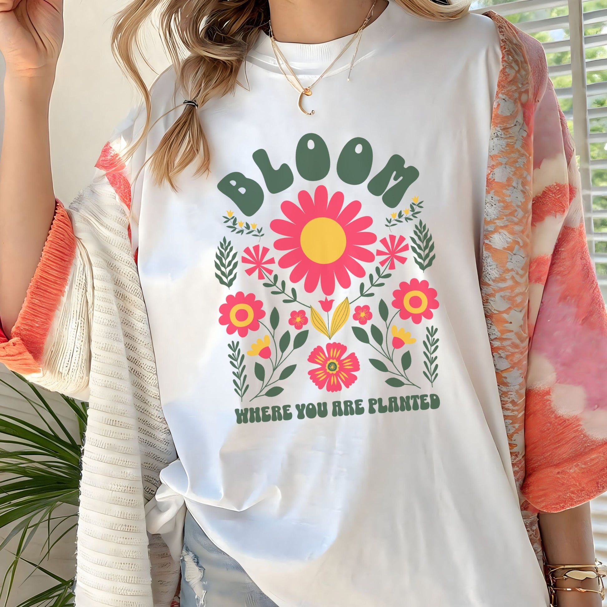 Person wearing a white t-shirt with floral design and text