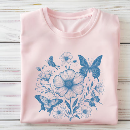 Pink t-shirt with blue floral and butterfly design on a wooden surface