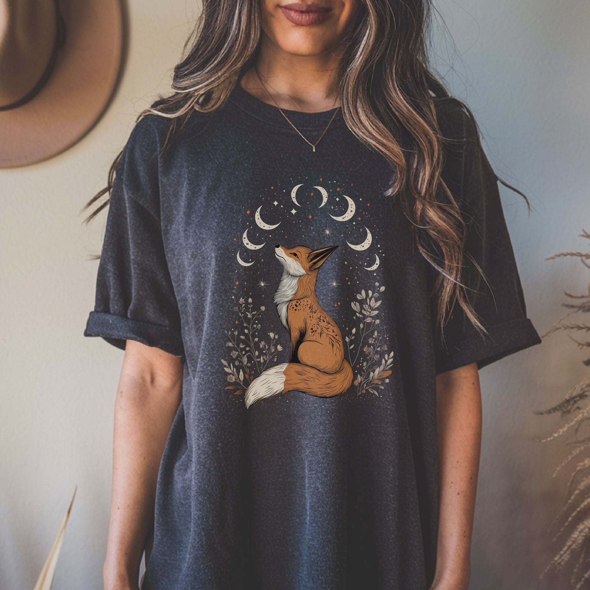 Person wearing a t-shirt with a fox and moon design