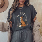 Person wearing a dark heather gray t-shirt with a fox graphic and gray sweatpants, standing against a neutral wall.