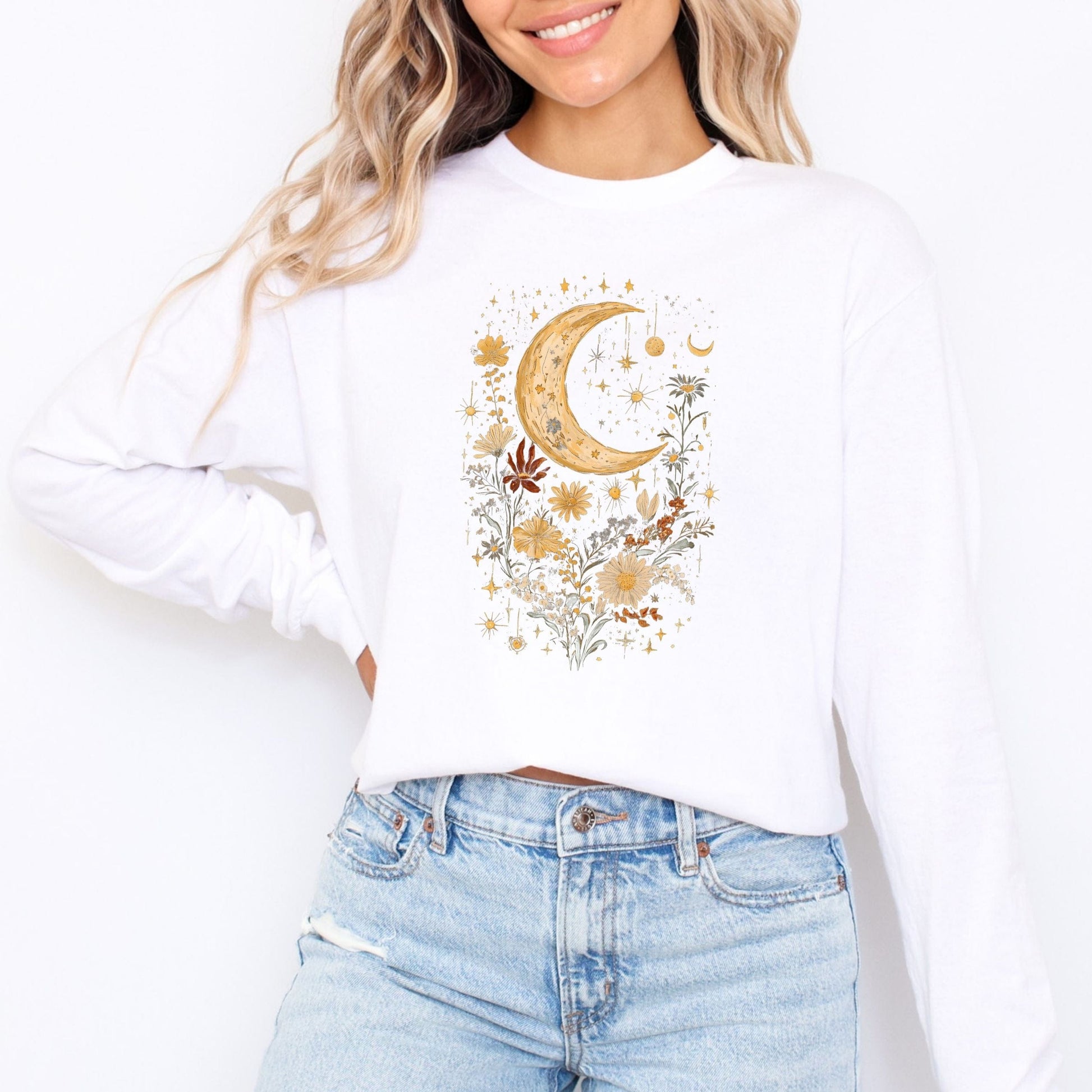 White long sleeve tee with a floral moon design worn by a person, on a white background