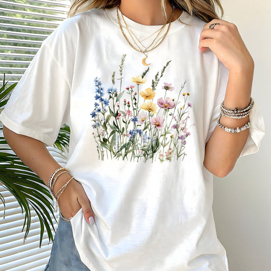 White t-shirt with floral design worn by a person, with a neutral background
