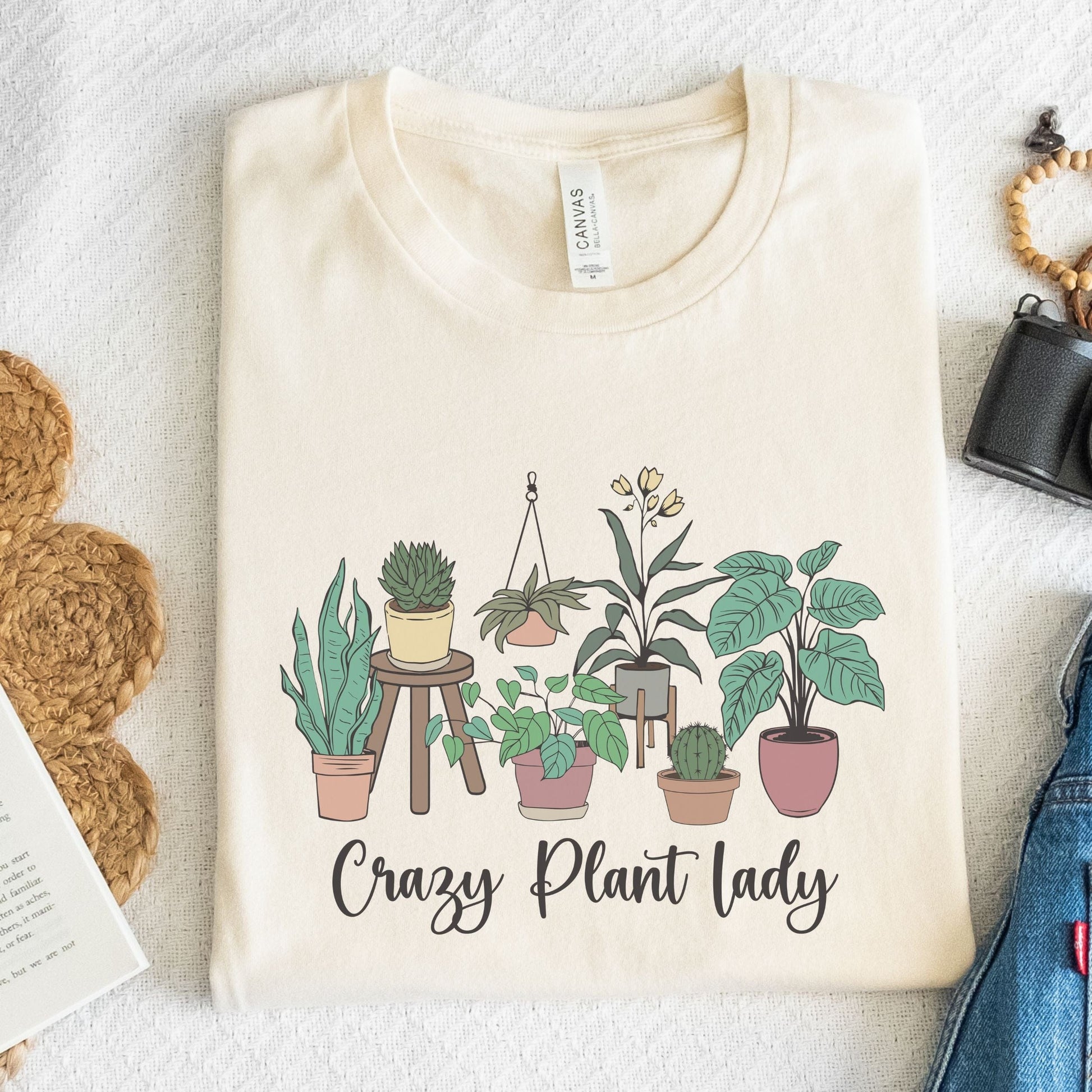 Beige t-shirt with plant illustrations and 'Crazy Plant Lady' text on a light background