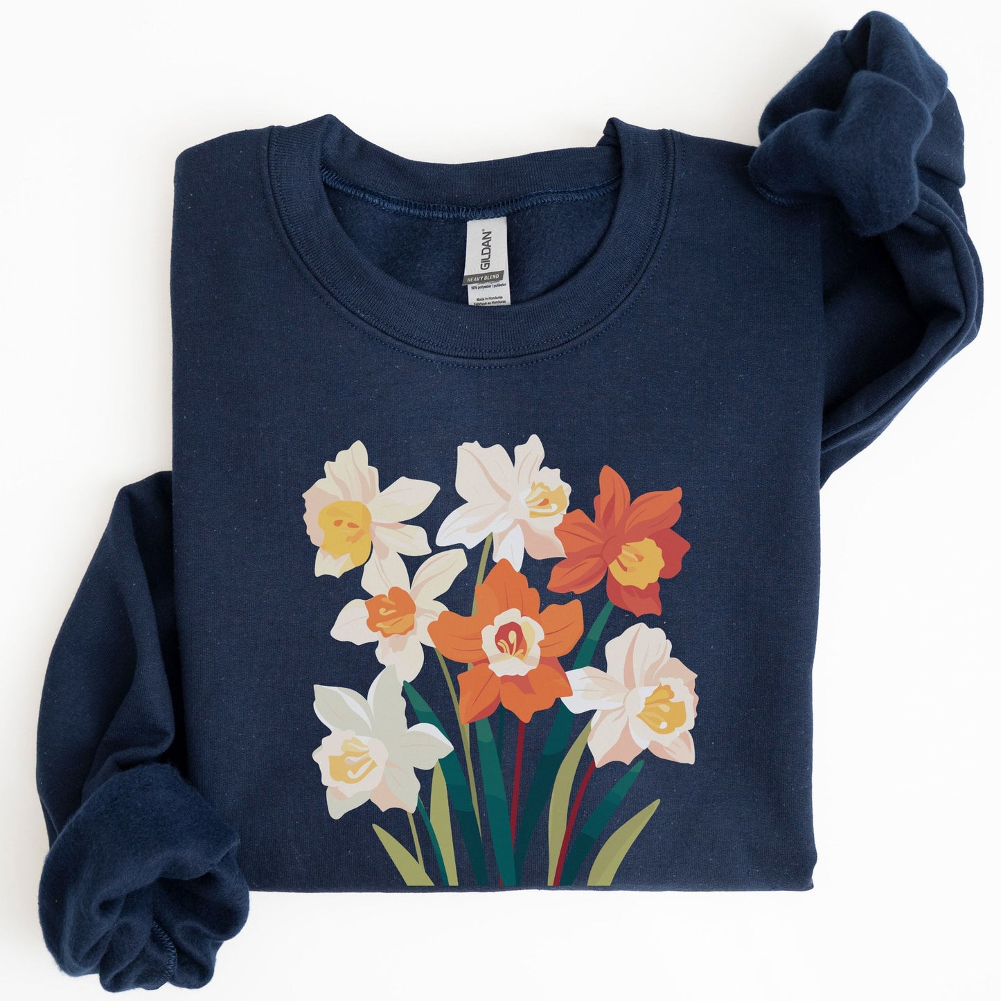 Folded navy blue sweatshirt with floral design on a white background