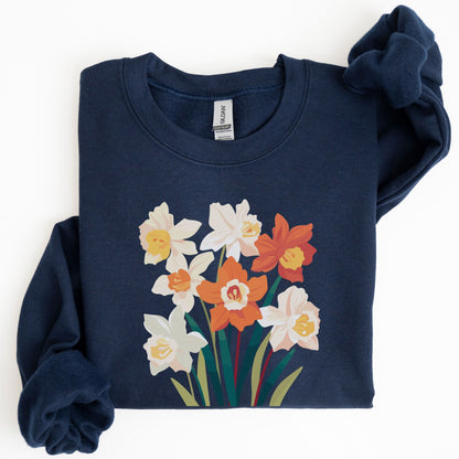 Folded navy blue sweatshirt with floral design on a white background