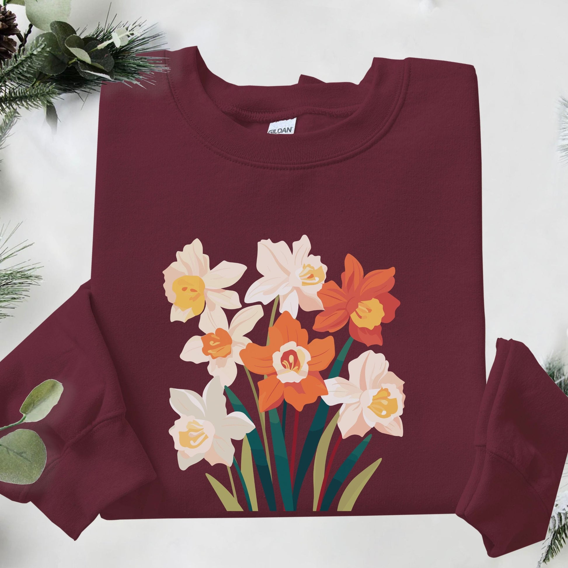 Maroon sweatshirt with floral design on a white background