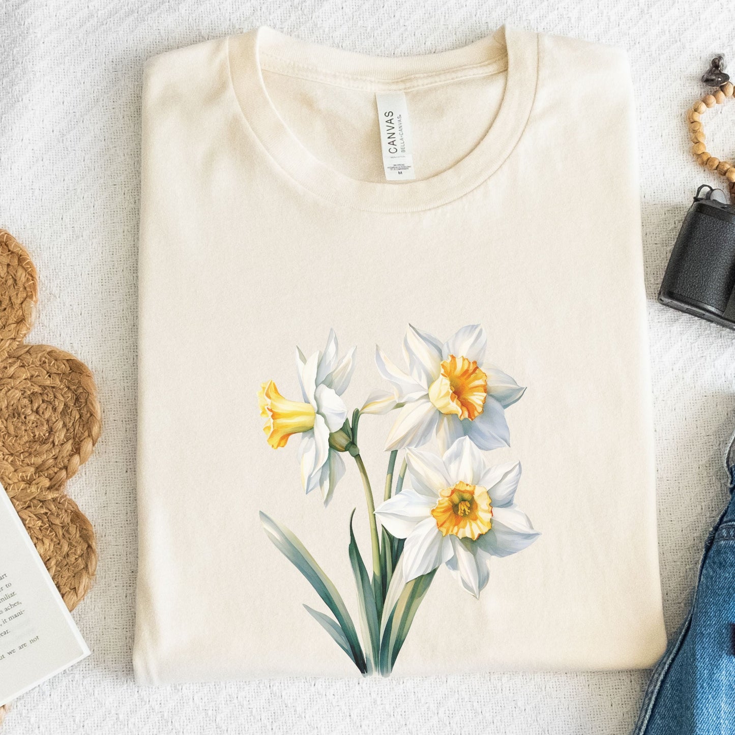 Beige t-shirt with floral design on a textured surface