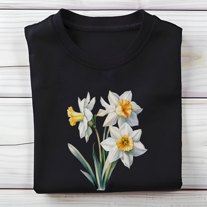 Black t-shirt with white daffodil flowers on a wooden surface