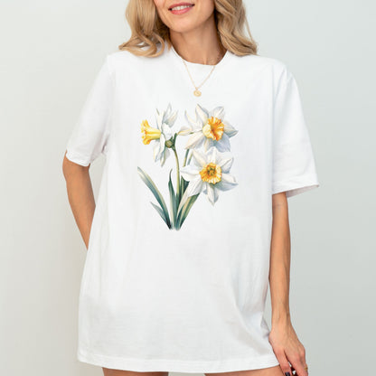 Woman wearing a white t-shirt with floral design on a plain background