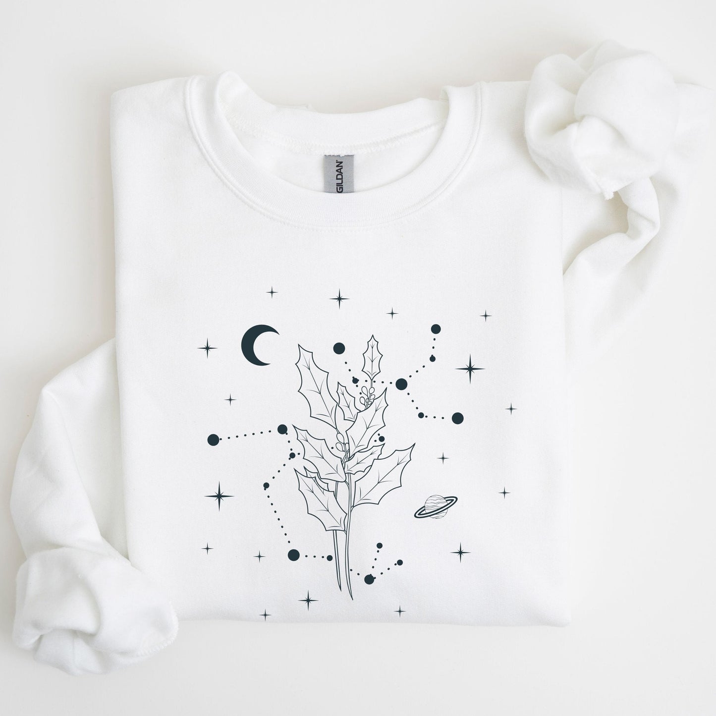 White sweatshirt with black celestial design on a light gray background