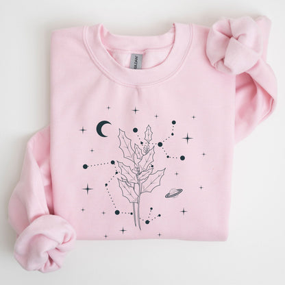 Pink sweatshirt with celestial design on a light gray background