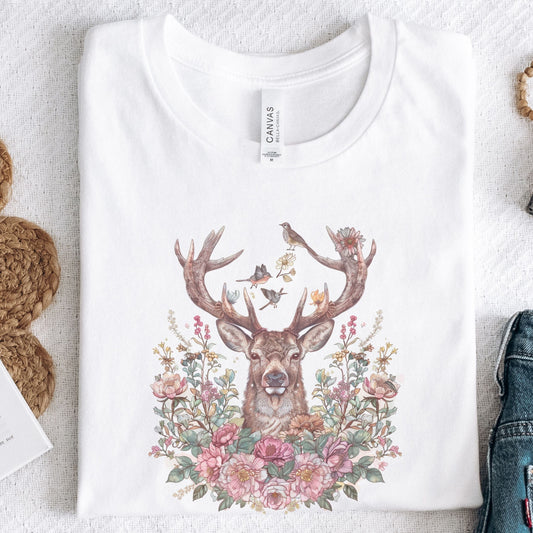 White t-shirt with a deer and floral design on a light background