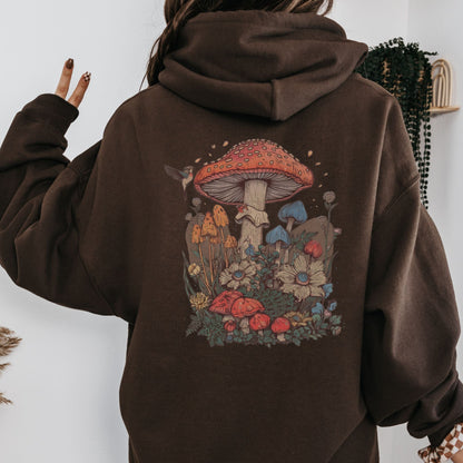 Brown hoodie with a mushroom design on the back, worn by a person.