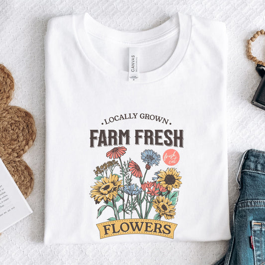 White t-shirt with 'Locally Grown, Farm Fresh Flowers' design on a light background