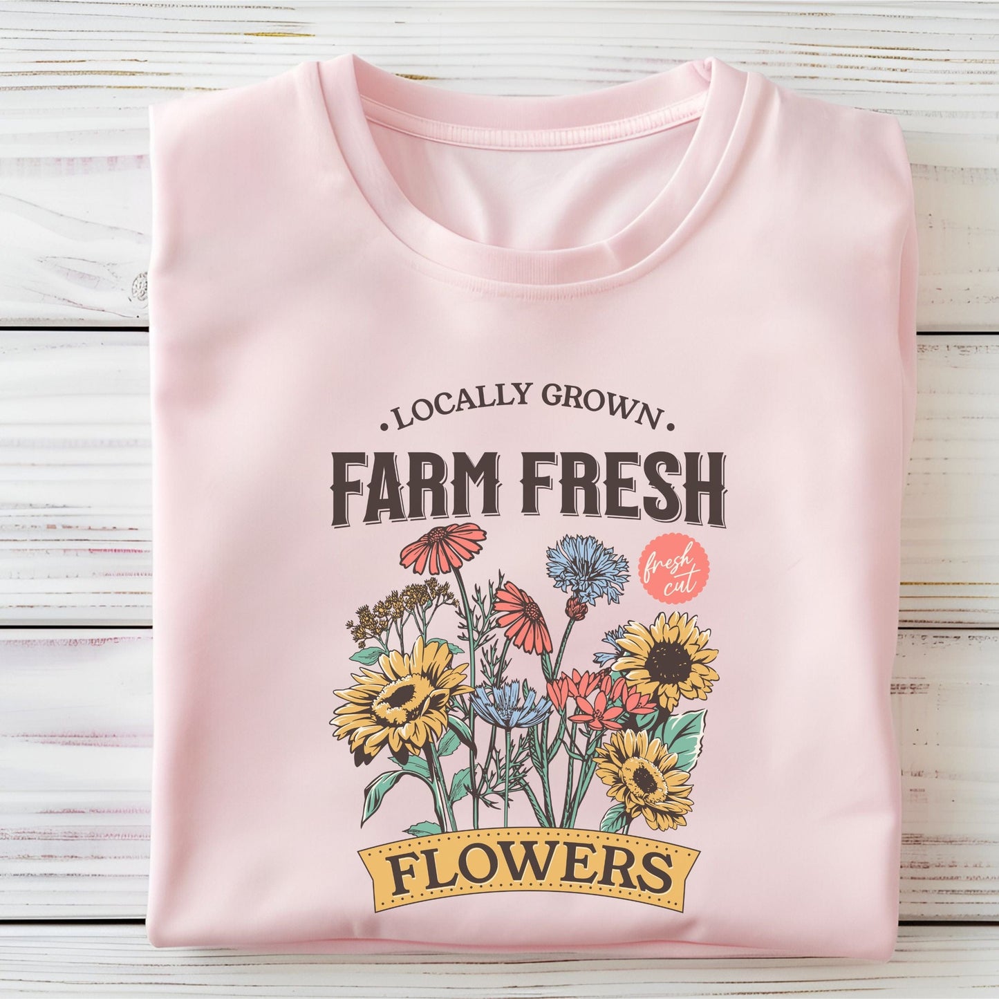 Soft pink t-shirt with 'Locally Grown, Farm Fresh Flowers' design on a light background