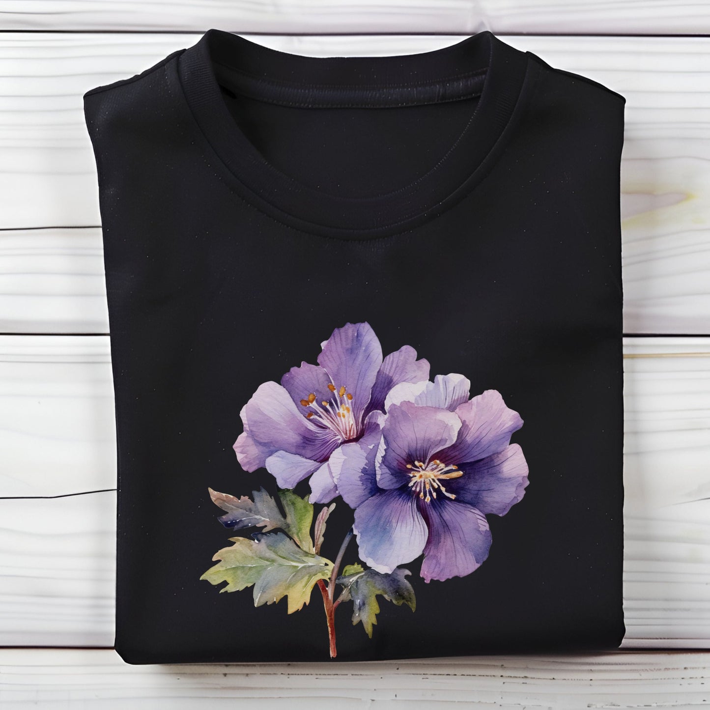 Black t-shirt with a purple floral design on a wooden surface