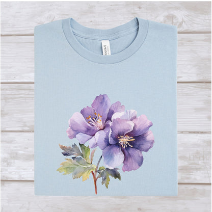 Light blue t-shirt with a purple floral design on a wooden surface