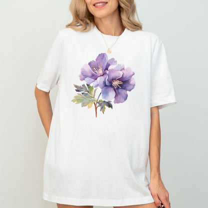 Woman wearing a white t-shirt with a purple floral design on a plain background