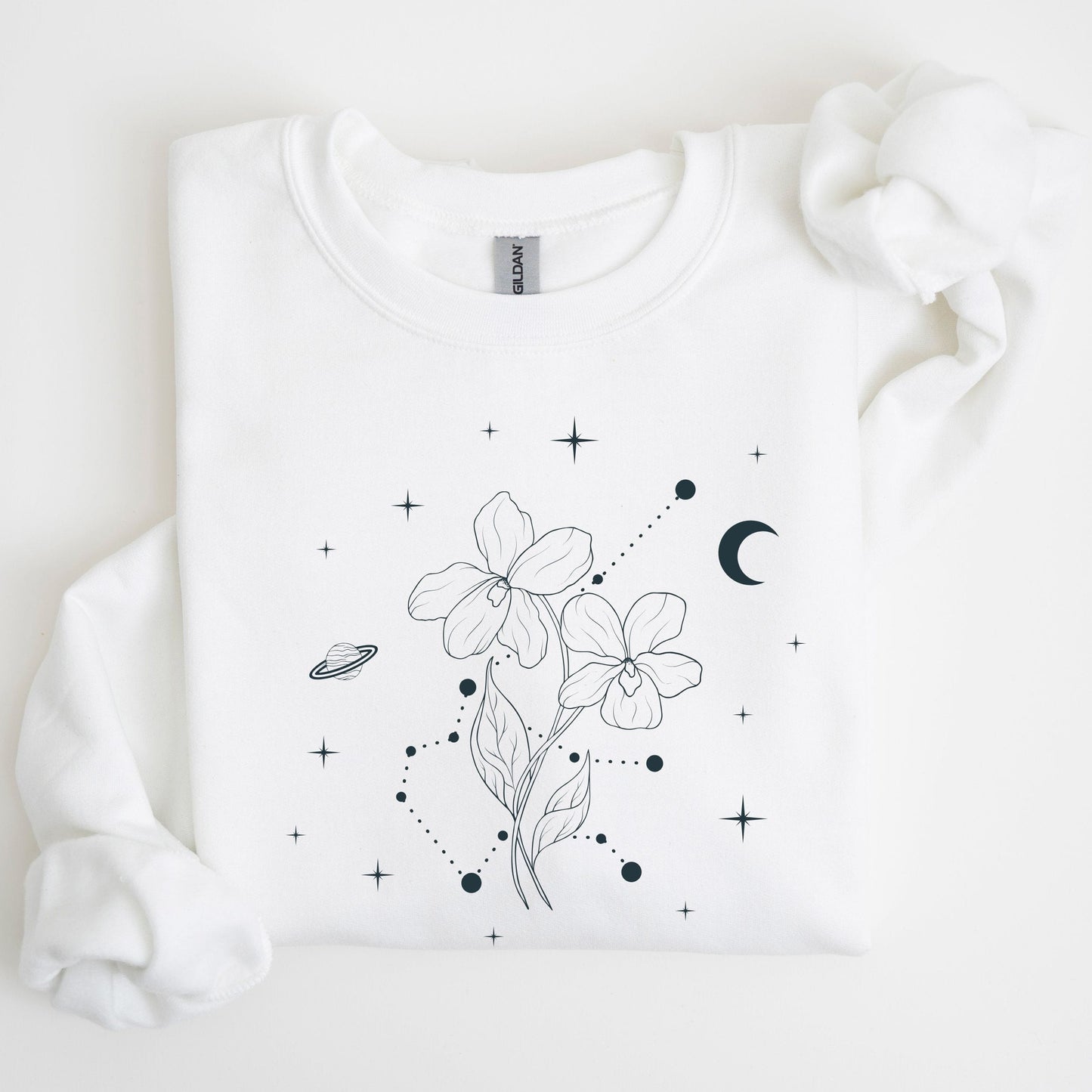 White sweatshirt with black floral and celestial design on a light background