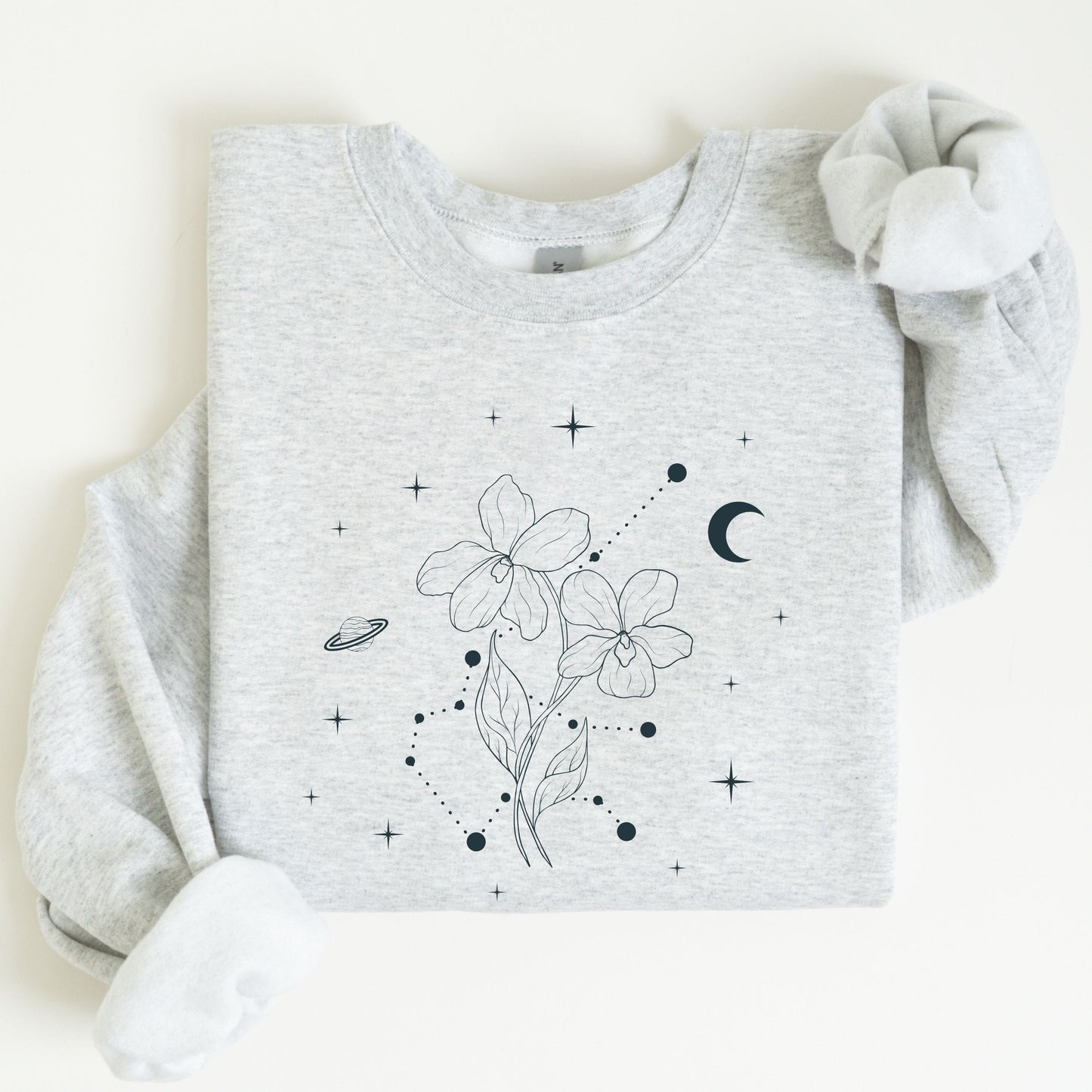 Gray sweatshirt with floral and celestial design on a white background