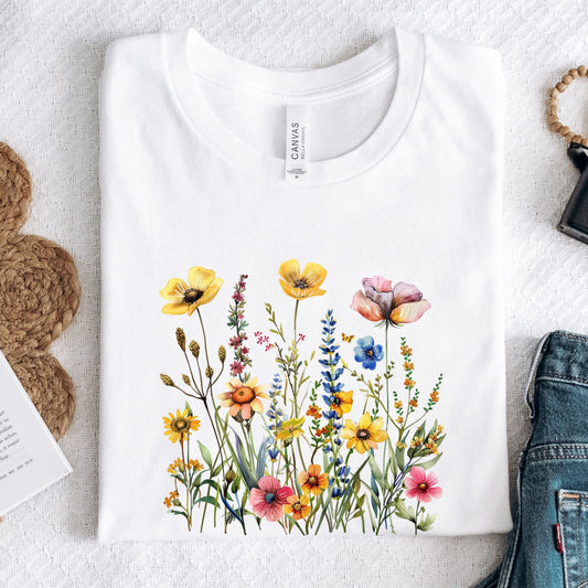 White t-shirt with colorful floral design on a light gray surface