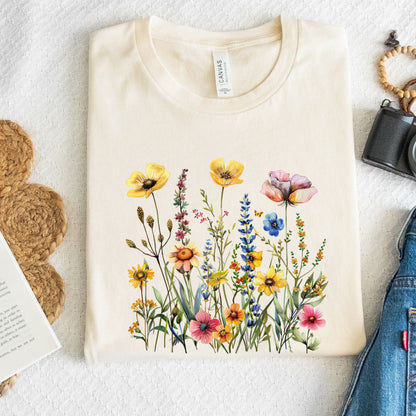 Beige t-shirt with colorful floral design on a light gray surface